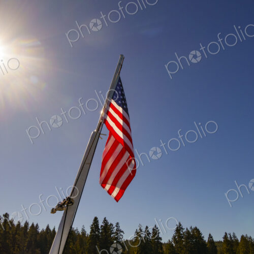 US Flag on flag pole, Hood Canal, WA USA