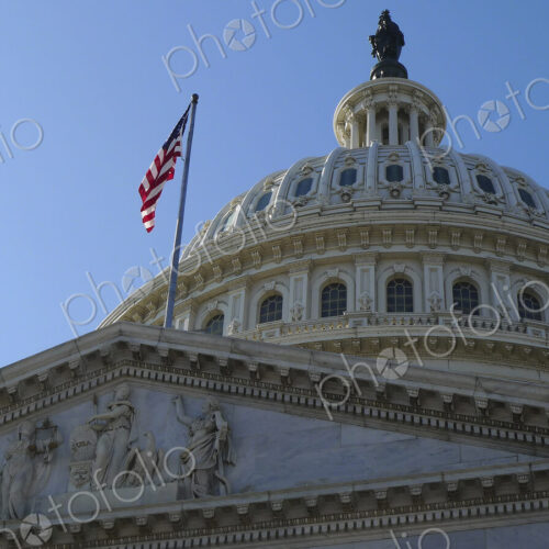 USA Capitol Building dome with American flag flying.