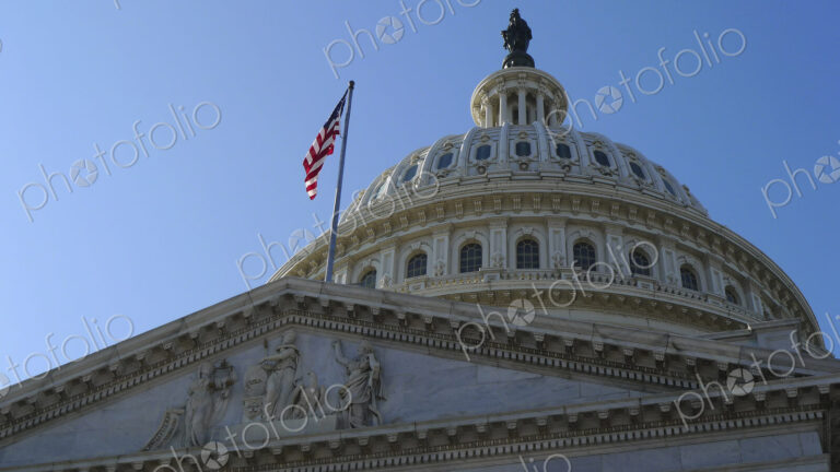 USA Capitol Building dome with American flag flying.