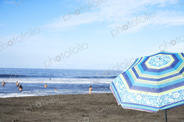 Umbrella on beach under blue sky
