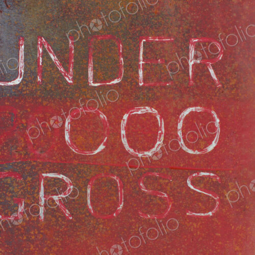 "Under 000 Gross" painted on side of old truck door "Under 000 Gross" painted on side of old truck door