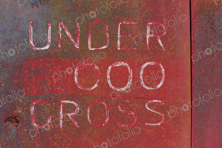 "Under 000 Gross" painted on side of old truck door