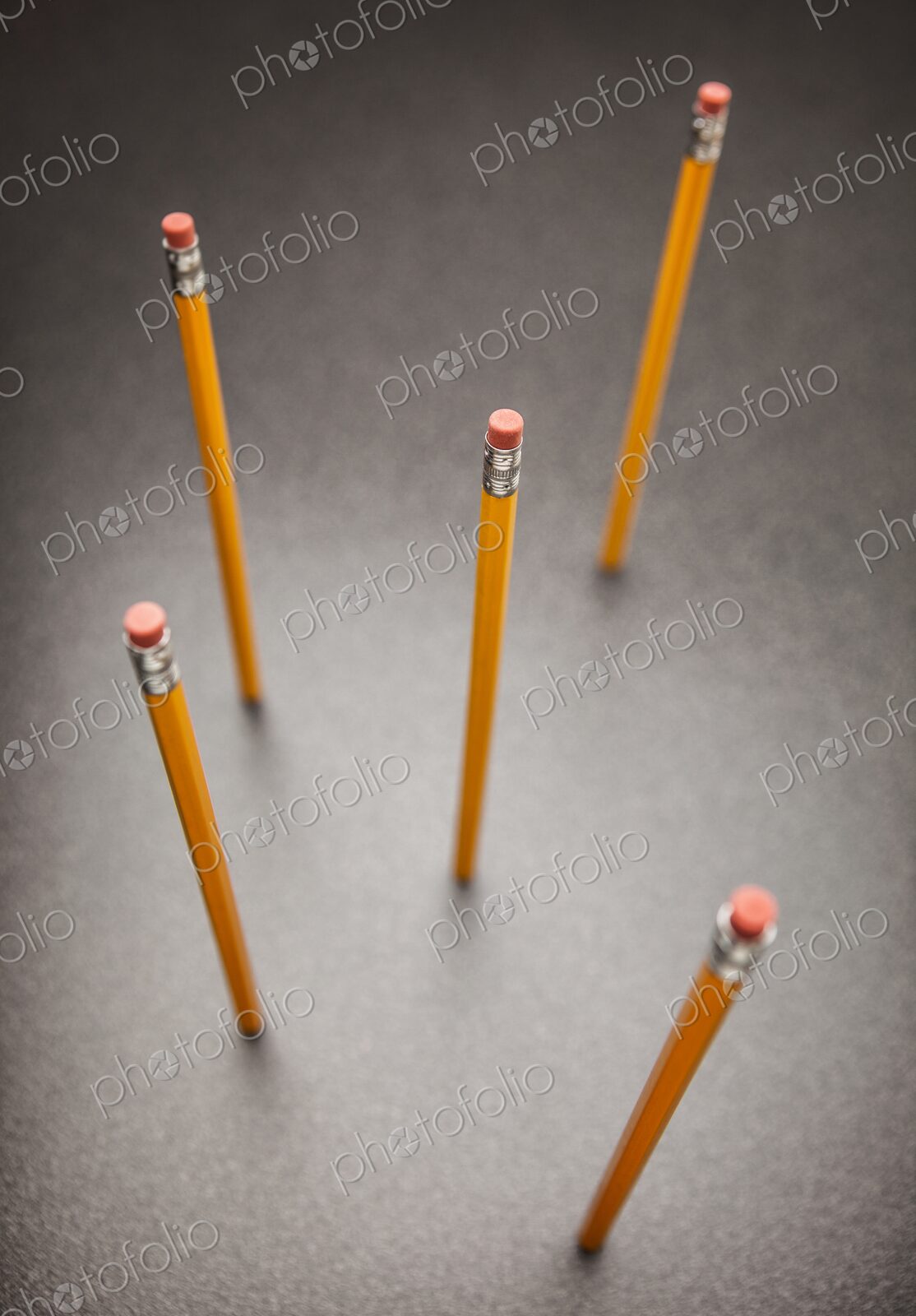 Unsharpened yellow no.2 pencils standing up on desk, view from above