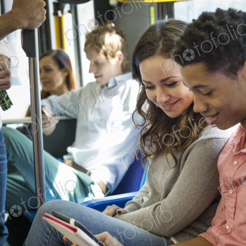 Urban Lifestyle. A group of people, men and women on a city bus, in New York city. A… Urban Lifestyle. A group of people, men and women on a city bus, in New York city. A…