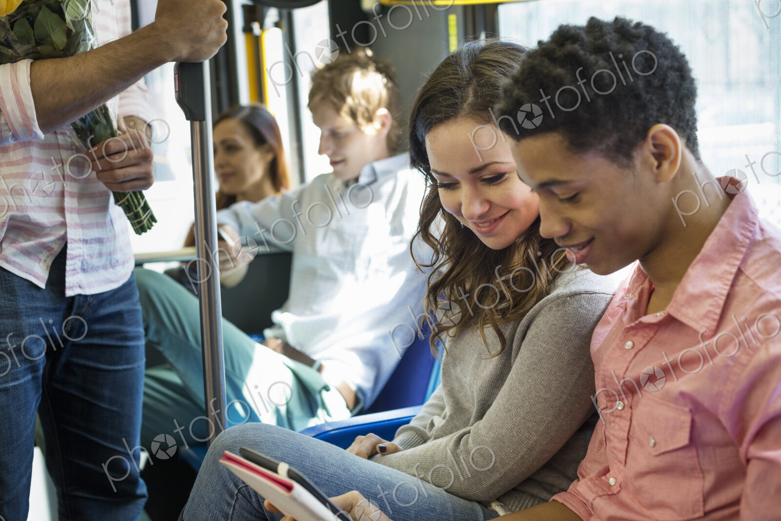 Urban Lifestyle. A group of people, men and women on a city bus, in New York city. A…