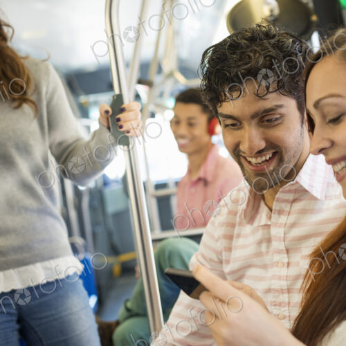 Urban Lifestyle. A group of people, men and women on a city bus, in New York city. A… Urban Lifestyle. A group of people, men and women on a city bus, in New York city. A…