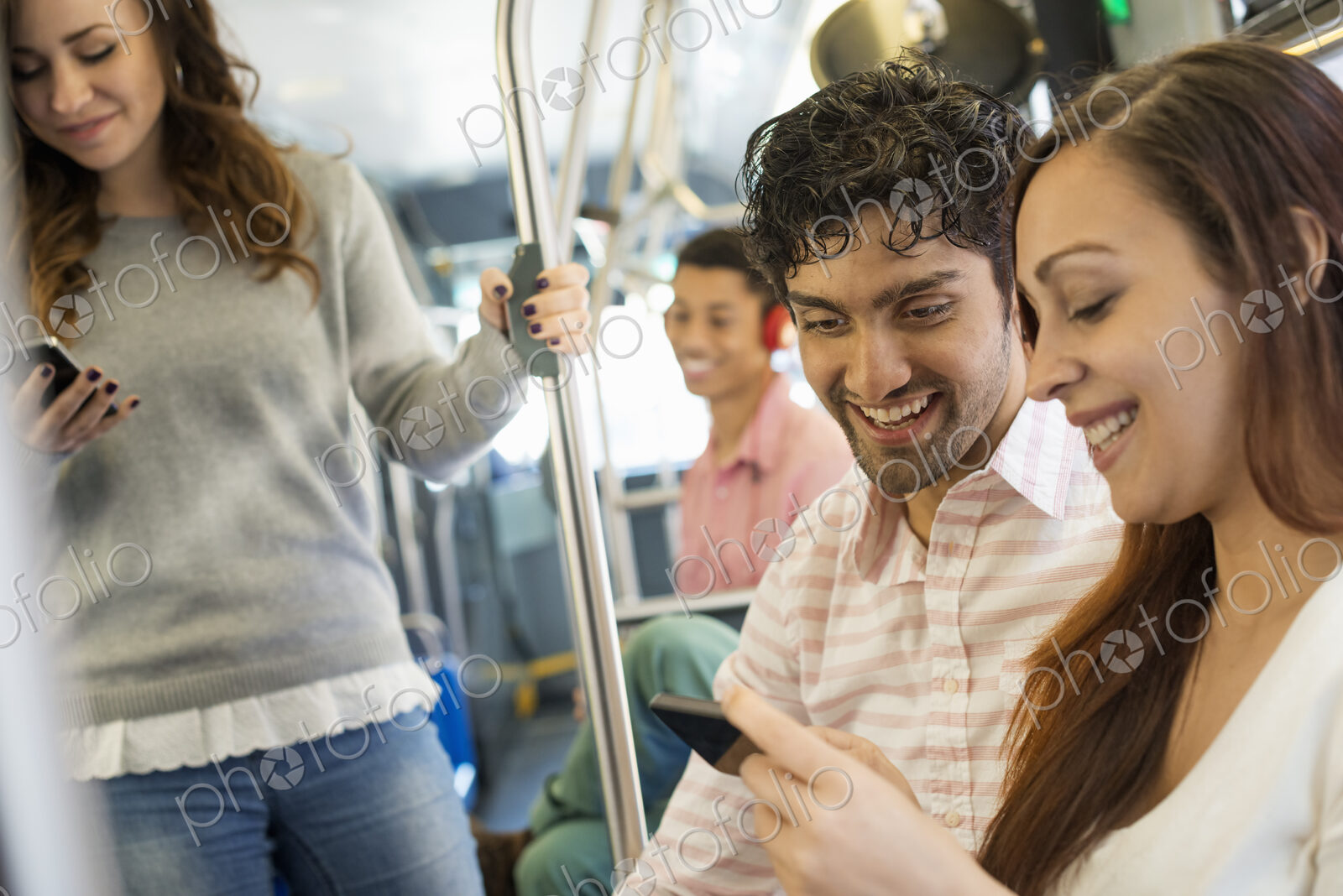 Urban Lifestyle. A group of people, men and women on a city bus, in New York city. A…