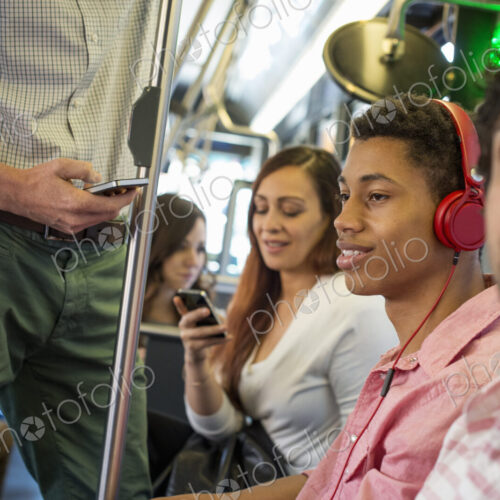 Urban Lifestyle. A group of people, men and women on a city bus, in New York city. A… Urban Lifestyle. A group of people, men and women on a city bus, in New York city. A…