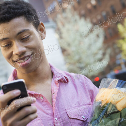 Urban Lifestyle. A young man with short black hair, wearing a pink casual shirt.… Urban Lifestyle. A young man with short black hair, wearing a pink casual shirt.…