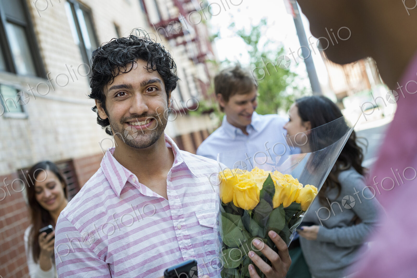 Urban Lifestyle. New York city street. A group of five people, one man carrying a…