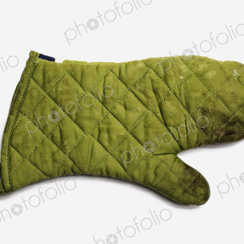 Used Oven Mitt. A quilted padded fabric, green, heat resistant mitt. Used Oven Mitt. A quilted padded fabric, green, heat resistant mitt.