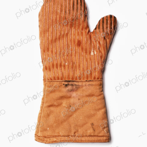 Used Oven Mitt. An orange fabric heat resistant mitt. Used Oven Mitt. An orange fabric heat resistant mitt.