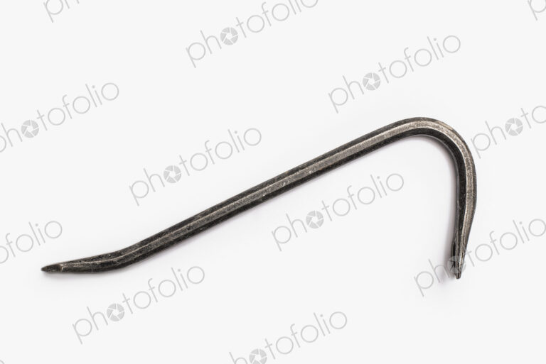 Used Tools. A crowbar, a metal objects with two curved ends. A tool for levering.