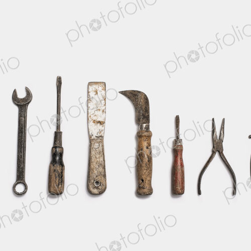 Used tools arranged in a row. Well used, worn handles, shaped wooden smooth texture.… Used tools arranged in a row. Well used, worn handles, shaped wooden smooth texture.…
