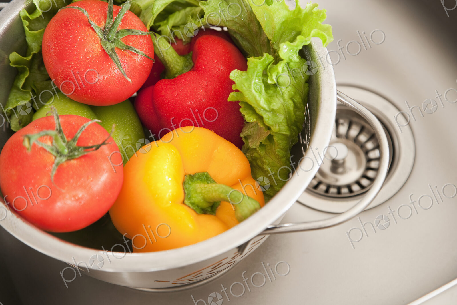 Vegetables in Colander, fresh washed in a sink