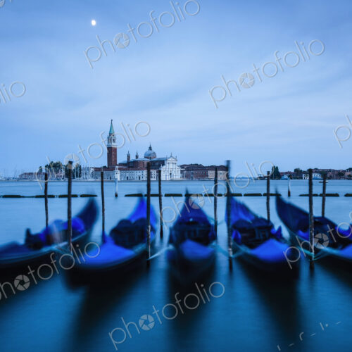 Venice lagoon, The Guideca viewed across the lagoon, gondolas moored, at night, moonlight. Venice lagoon, The Guideca viewed across the lagoon, gondolas moored, at night, moonlight.