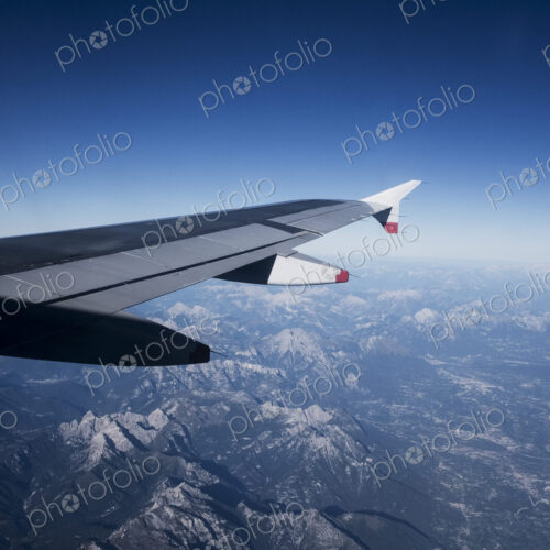 View across the Alps seen from a passenger plane window. View across the Alps seen from a passenger plane window.
