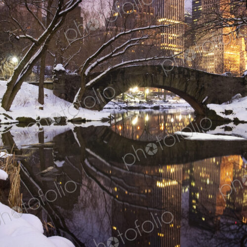 View across the Pond towards Gapstow Bridge in Central Park in Manhattan after a snow… View across the Pond towards Gapstow Bridge in Central Park in Manhattan after a snow…