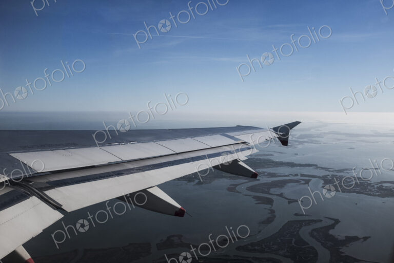View across the Venice lagoon seen from a passenger plane window, Veneto, Italy.