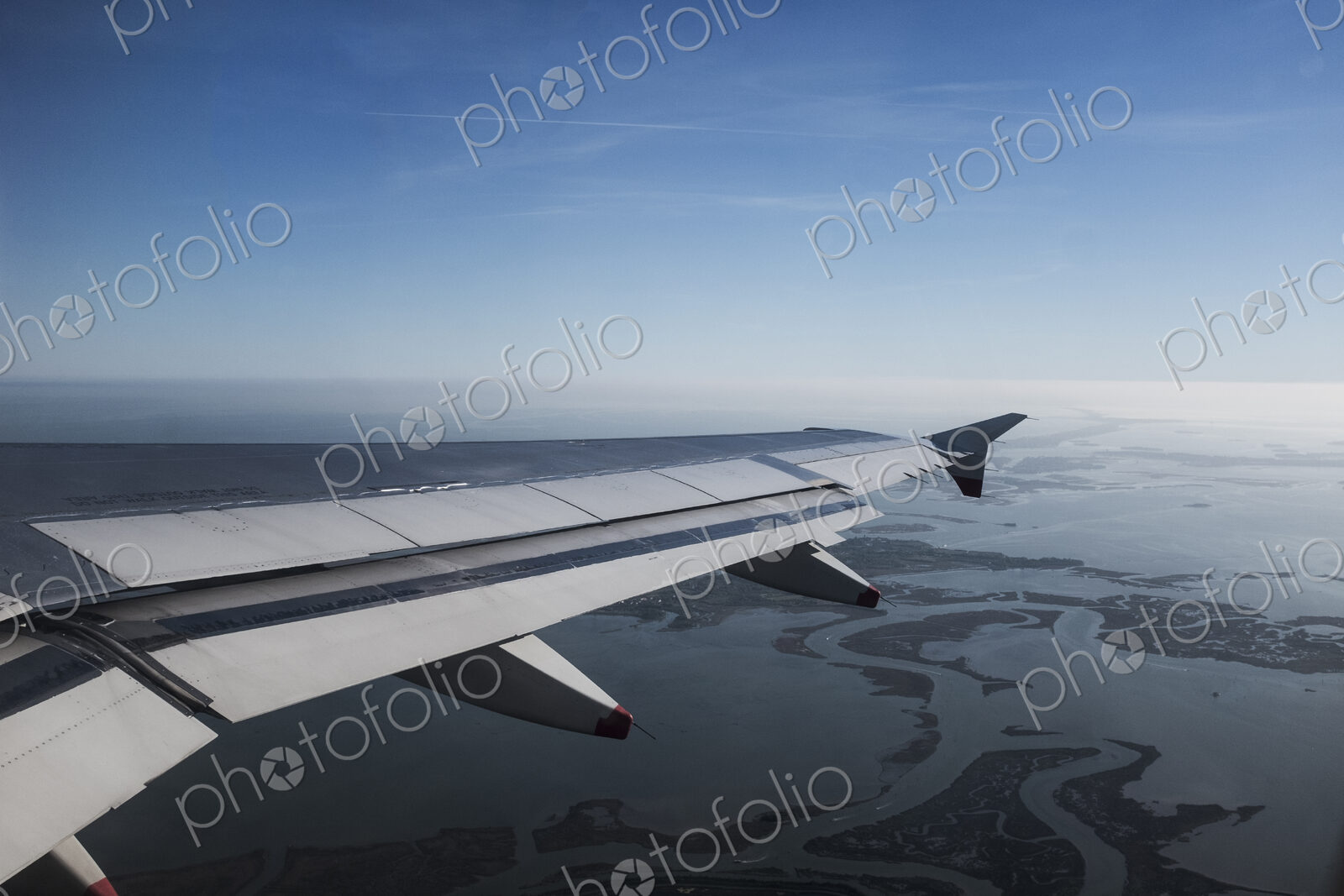 View across the Venice lagoon seen from a passenger plane window, Veneto, Italy.
