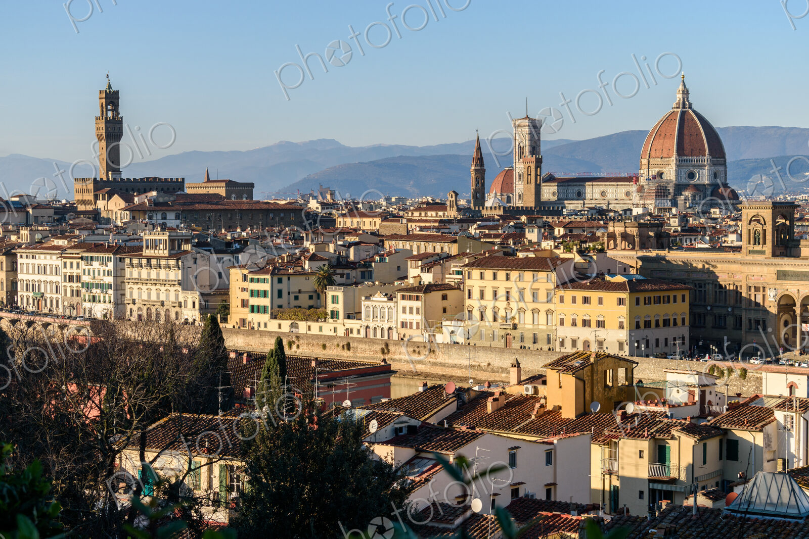 View across the rooftops of Florence, historic renaissance architectural landmarks,…