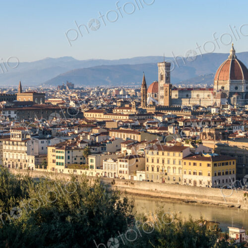 View across the rooftops of Florence, historic renaissance architectural landmarks,…