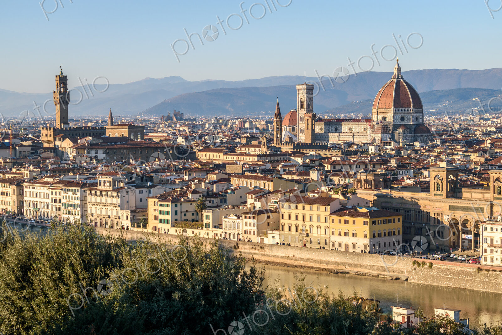 View across the rooftops of Florence, historic renaissance architectural landmarks,…