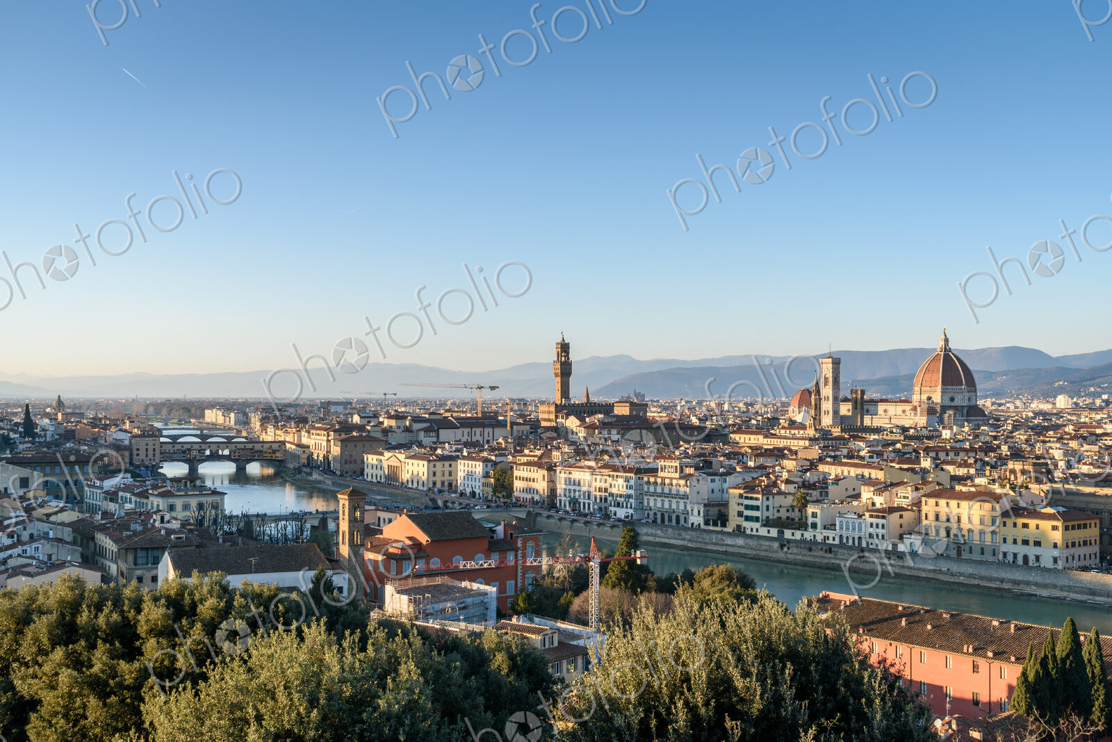 View across the rooftops of Florence, historic renaissance architectural landmarks,…