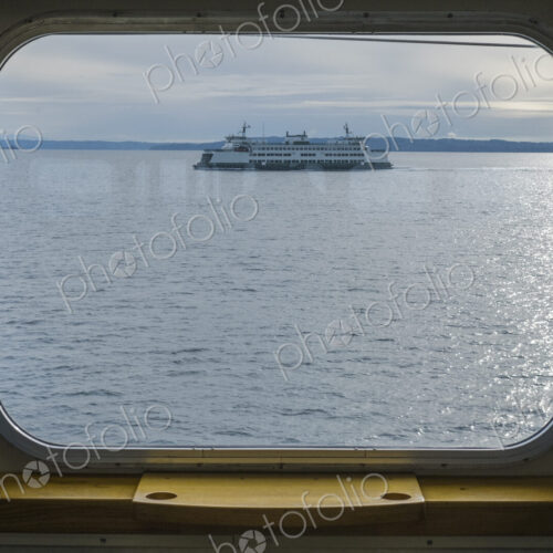 View across water from a ferry boat window, a ferry in Puget Sound, View across water from a ferry boat window, a ferry in Puget Sound,