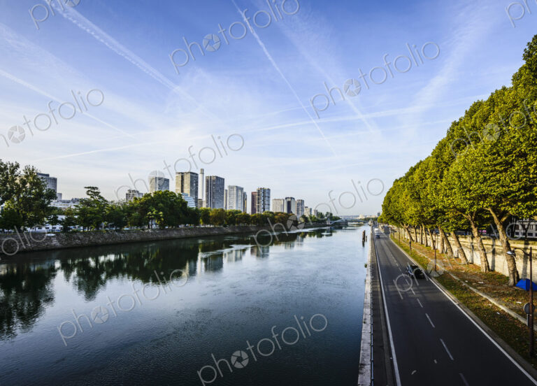View along the River Seine, a road by the water, high rise buildings.