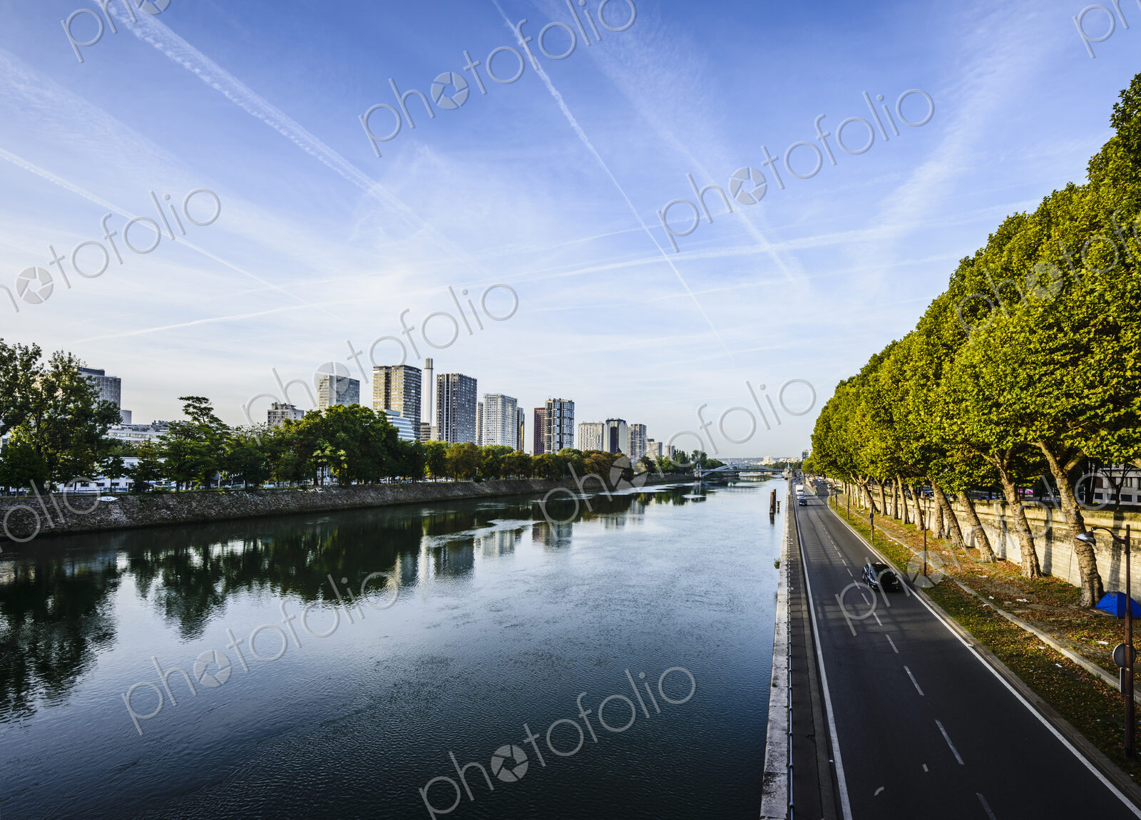 View along the River Seine, a road by the water, high rise buildings.