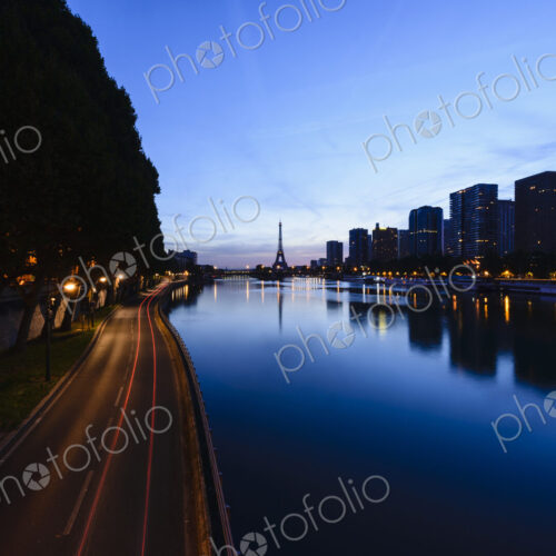 View along the River Seine to the Eiffel tower, the river embankment, and the city at… View along the River Seine to the Eiffel tower, the river embankment, and the city at…