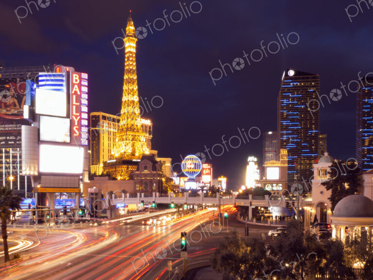 View along the Strip in Las Vegas at night, with the illuminated Paris Las Vegas Hotel…