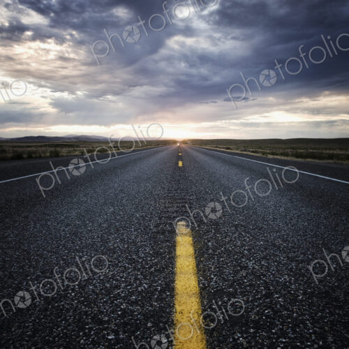 View down the center line of a state highway at sunset in eastern Washington, USA. View down the center line of a state highway at sunset in eastern Washington, USA.