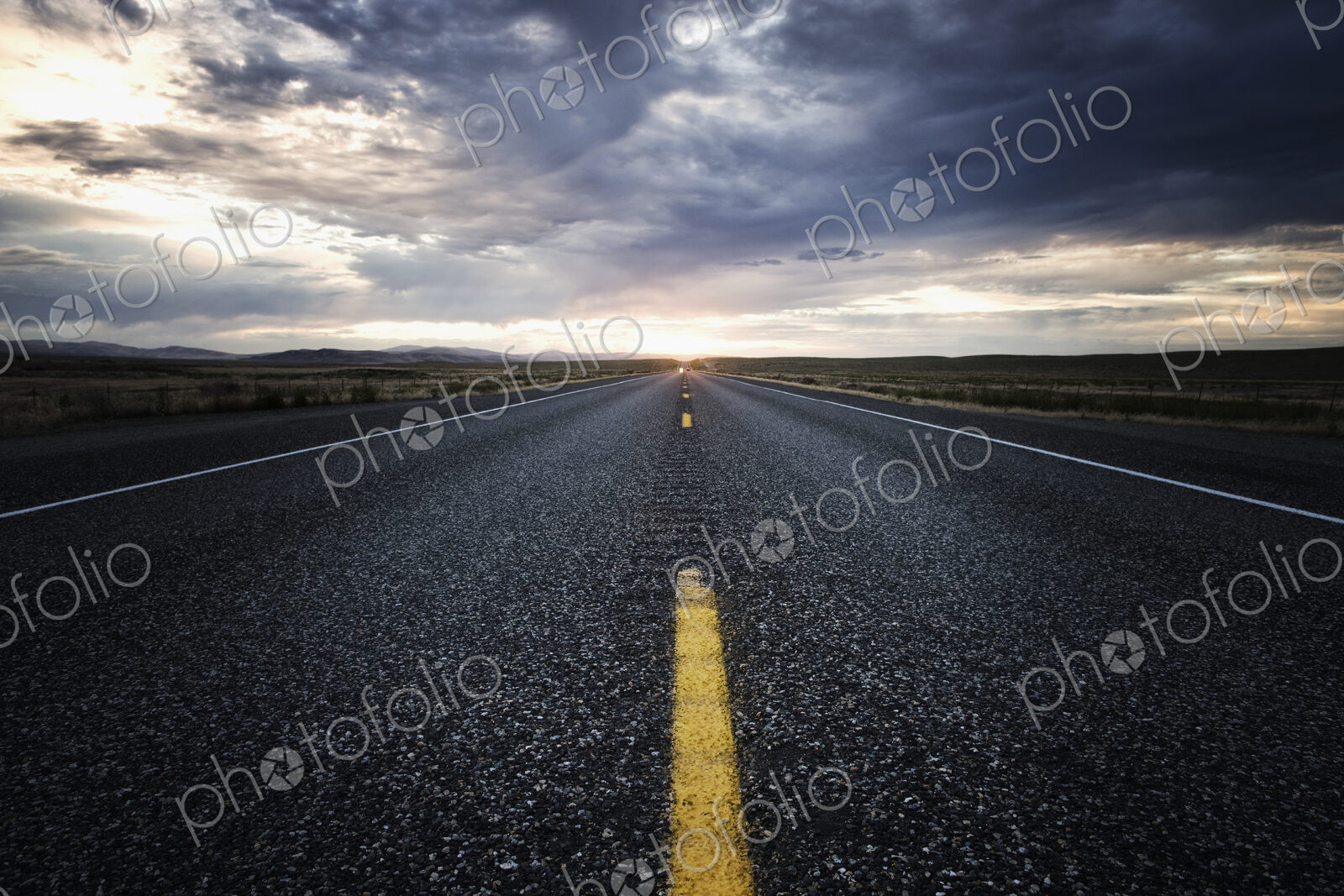 View down the center line of a state highway at sunset in eastern Washington, USA.