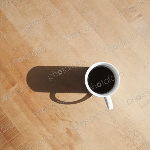 View from above of black coffee in a mug. View from above of black coffee in a mug.