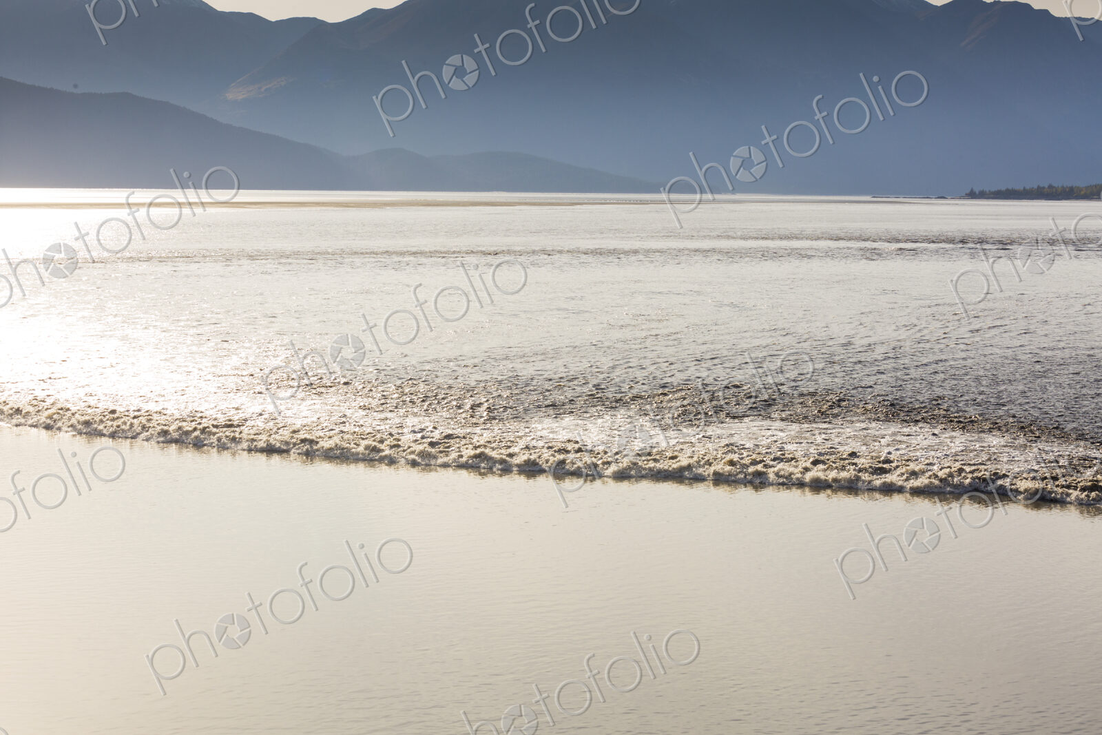 View from above of the Turnagain Arm Tidal Bore, a rolling wave of water which surges…