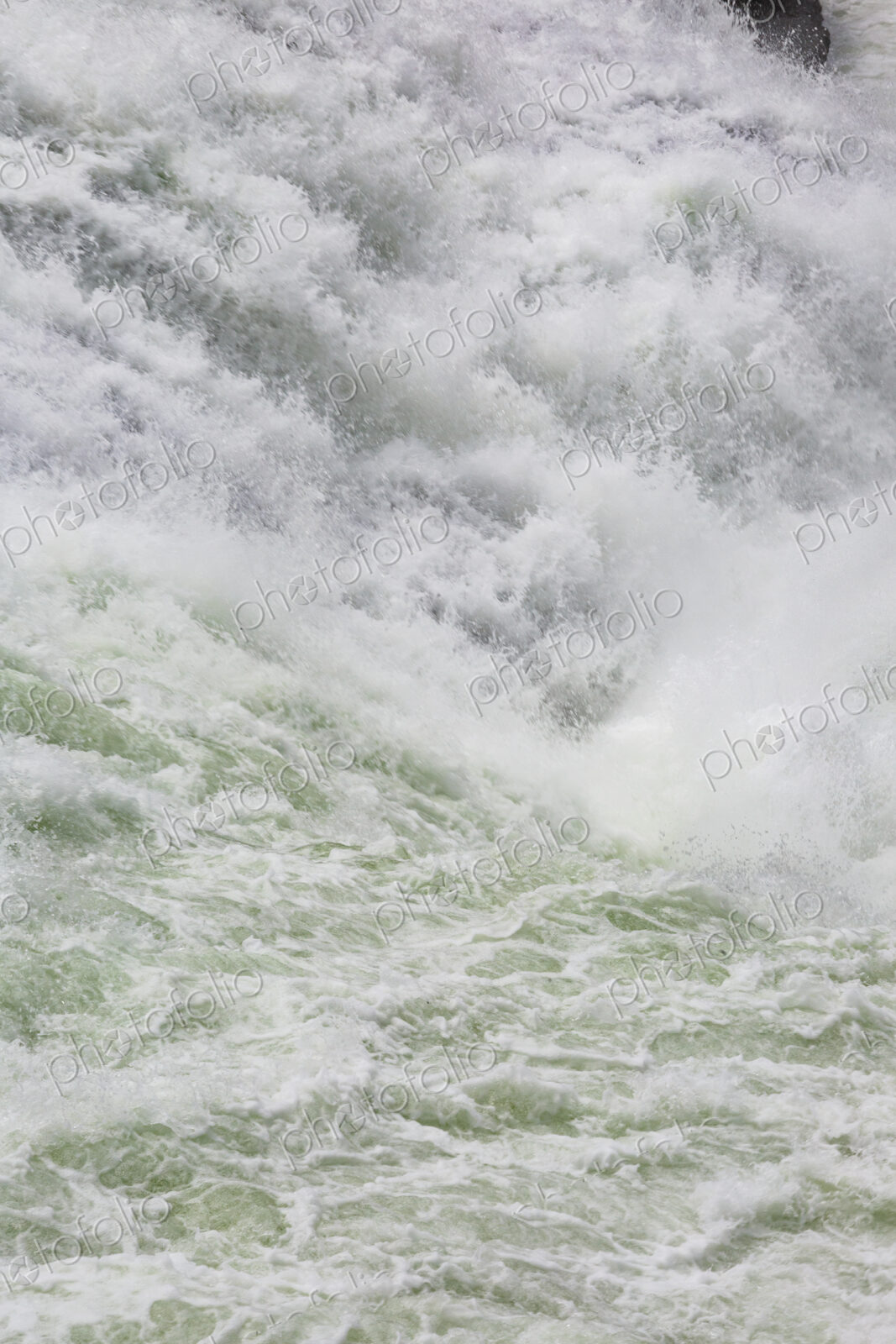View from above of the torrents of the Spokane Falls, full frame, white water.