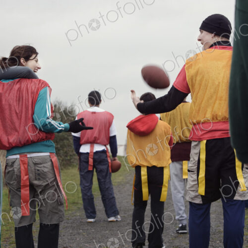 View from behind of a group of friends getting ready for an American Flag Football game. View from behind of a group of friends getting ready for an American Flag Football game.