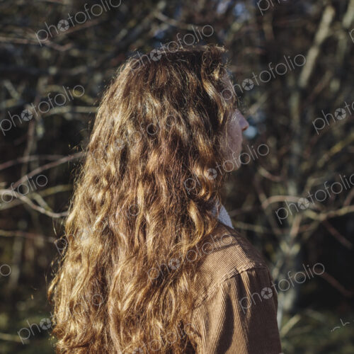 View from behind of teenage girl with long, wavy, brown hair View from behind of teenage girl with long, wavy, brown hair