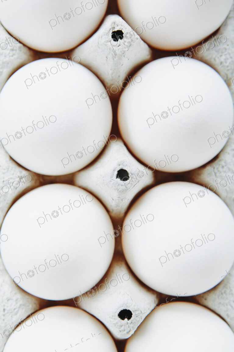 View from overhead of free range, organic eggs in a cardboard egg box carton.