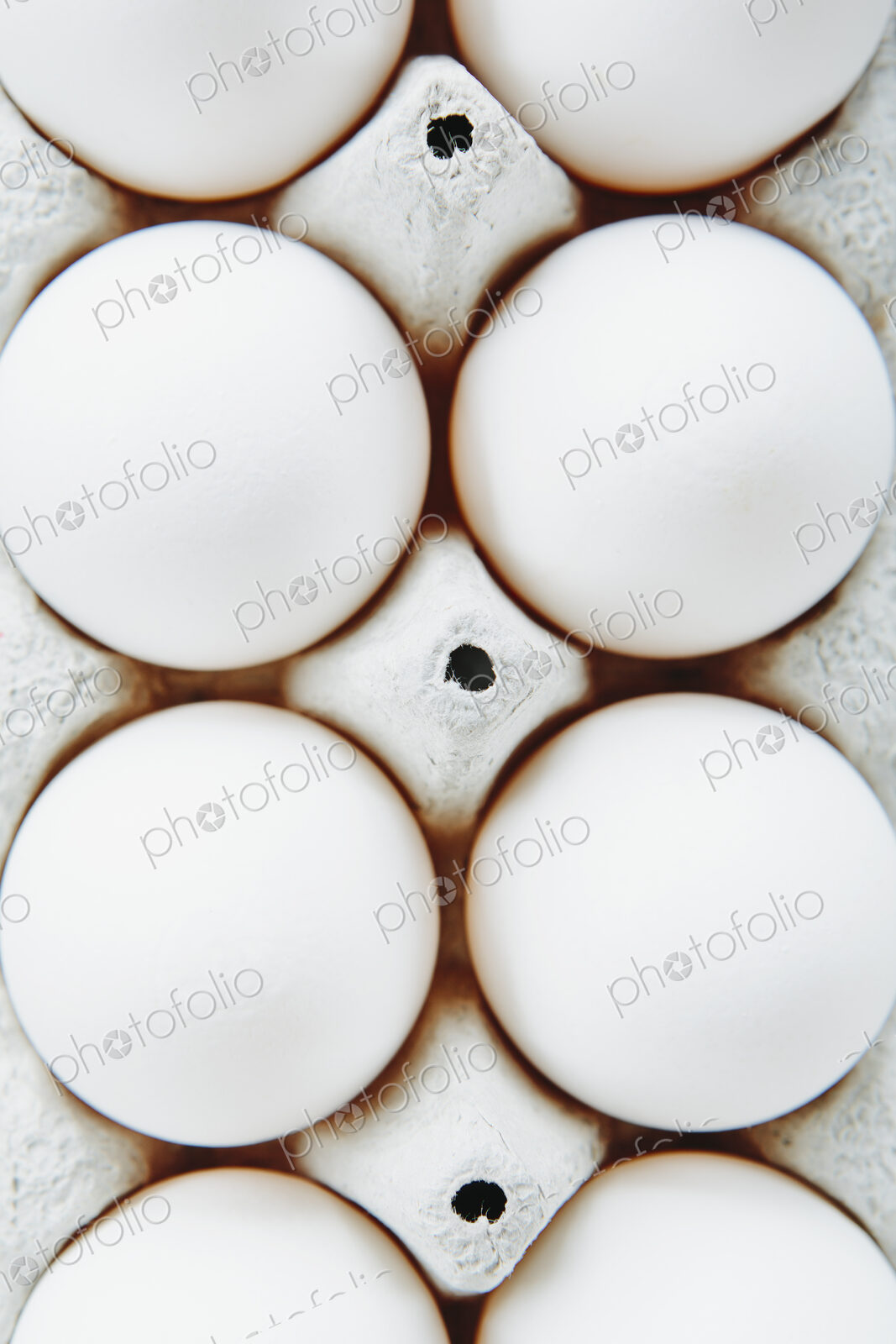 View from overhead of free range, organic eggs in a cardboard egg box carton.