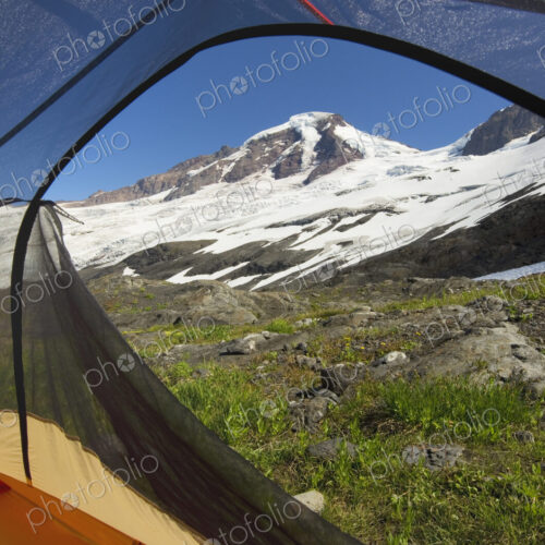 View from tent under snowy mountainside View from tent under snowy mountainside