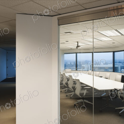 View from the outside of a conference room ready for business late in the day.