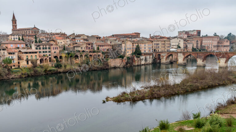 View of Albi, the city and historic buildings from the River Tarn, the Pont Vieux and…