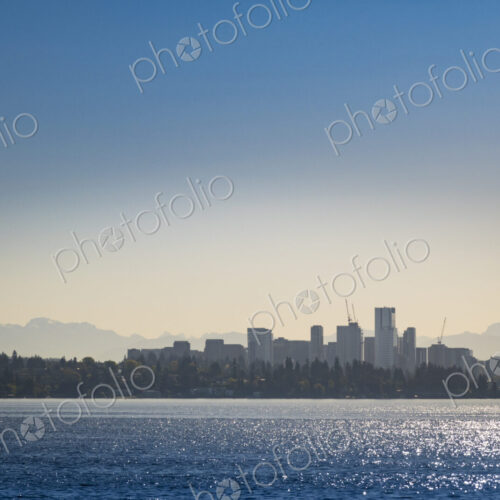 View of Bellevue downtown, tall buildings silhouetted against a sunset sky, view from… View of Bellevue downtown, tall buildings silhouetted against a sunset sky, view from…
