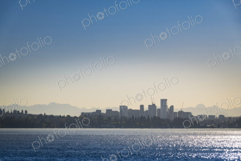 View of Bellevue downtown, tall buildings silhouetted against a sunset sky, view from…