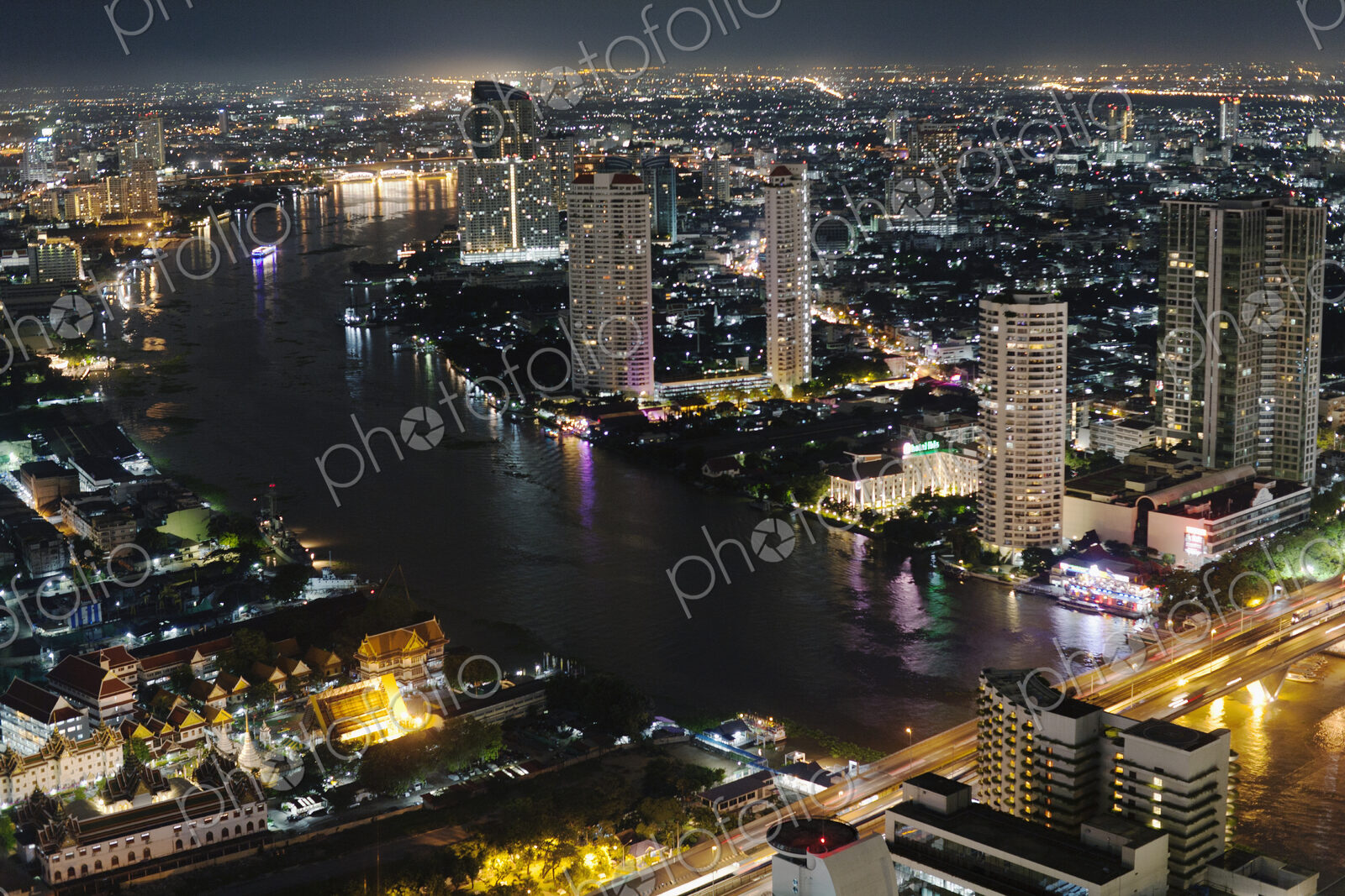 View of Chao Phraya River and the city centre at night, Bangkok, Thailand.