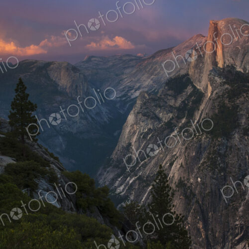 View of Half Dome in Yosemite Valley in Yosemite National Park, California at dusk. View of Half Dome in Yosemite Valley in Yosemite National Park, California at dusk.