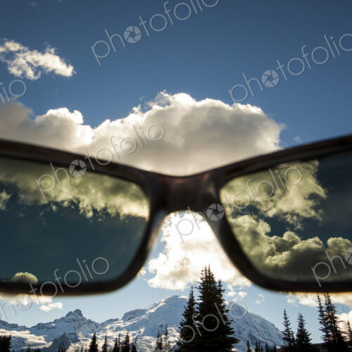 View of Mount Rainier peak though a pair of sunglasses in Mount Rainier National Park View of Mount Rainier peak though a pair of sunglasses in Mount Rainier National Park